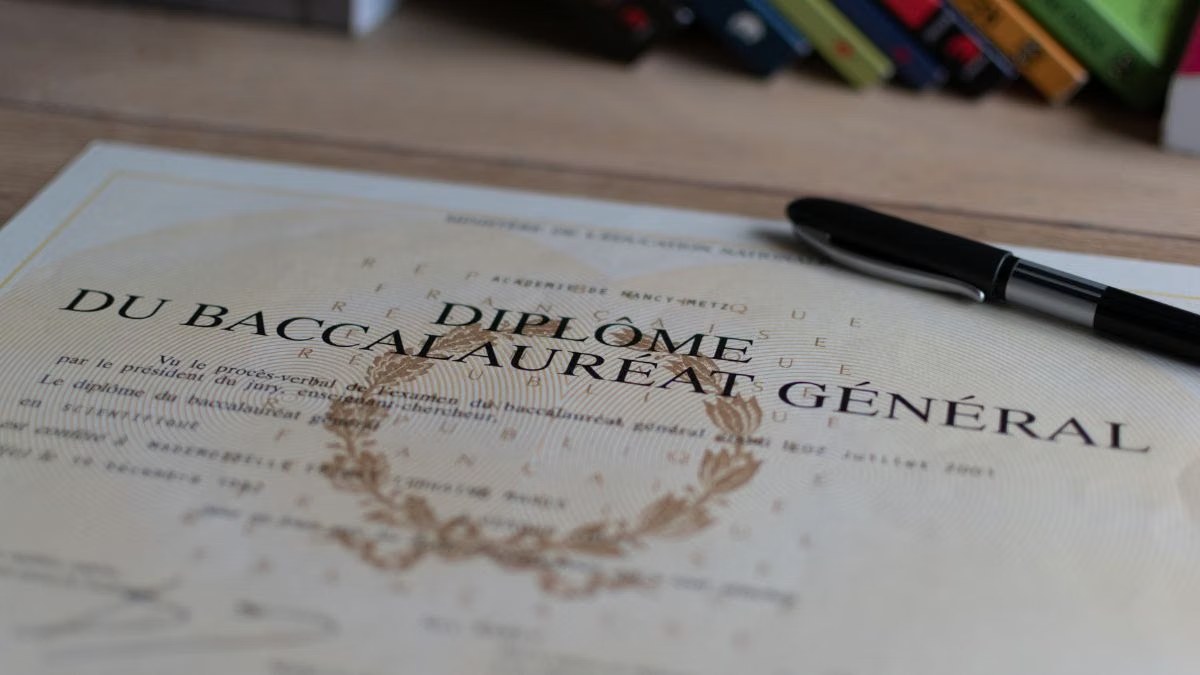 Documents administratifs et diplôme posés sur un bureau pour une demande de récupération